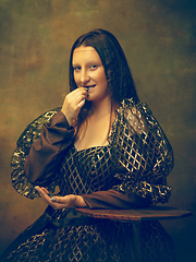 Image showing Young woman as Mona Lisa on dark background. Retro style, comparison of eras concept.