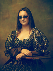 Image showing Young woman as Mona Lisa on dark background. Retro style, comparison of eras concept.