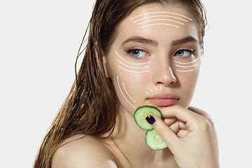 Image showing Youth secrets. Beautiful young woman over white background. Cosmetics and makeup, lifting and aging concept.