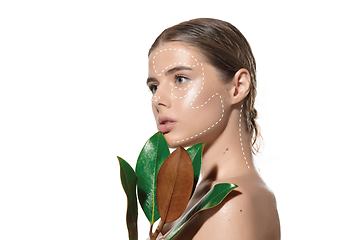 Image showing Youth secrets. Beautiful young woman over white background. Cosmetics and makeup, lifting and aging concept.