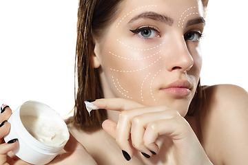 Image showing Youth secrets. Beautiful young woman over white background. Cosmetics and makeup, lifting and aging concept.