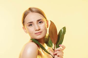 Image showing Youth secrets. Beautiful young woman over white background. Cosmetics and makeup, lifting and aging concept.