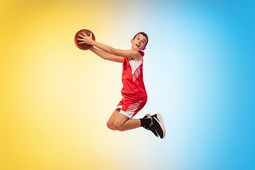 Image showing Full length portrait of a young basketball player with ball on gradient background