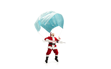 Image showing Santa Claus flying on huge face mask like on balloon isolated on white background