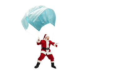 Image showing Santa Claus flying on huge face mask like on balloon isolated on white background