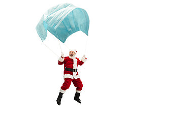 Image showing Santa Claus flying on huge face mask like on balloon isolated on white background