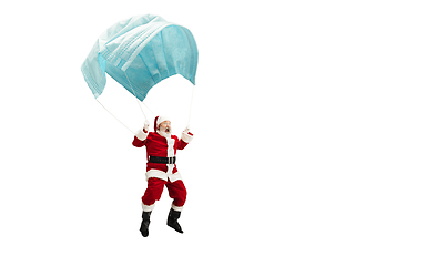 Image showing Santa Claus flying on huge face mask like on balloon isolated on white background