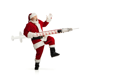 Image showing Santa Claus holding huge vaccine against COVID like Christmas gift isolated on white background