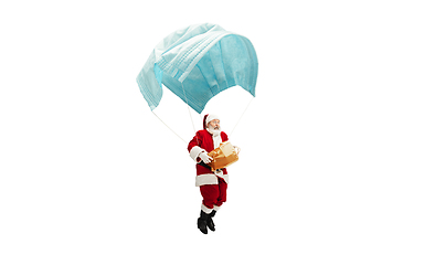 Image showing Santa Claus flying on huge face mask like on balloon isolated on white background