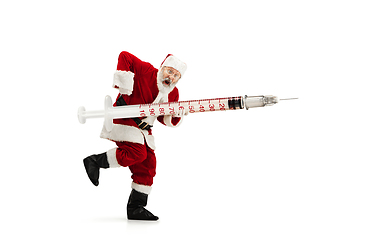 Image showing Santa Claus holding huge vaccine against COVID like Christmas gift isolated on white background