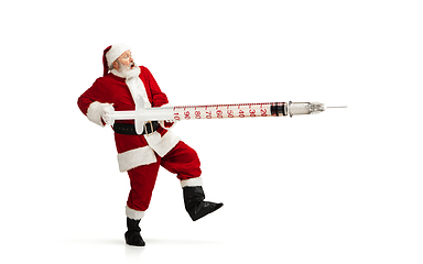 Image showing Santa Claus holding huge vaccine against COVID like Christmas gift isolated on white background