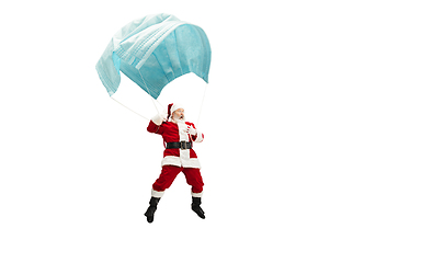 Image showing Santa Claus flying on huge face mask like on balloon isolated on white background