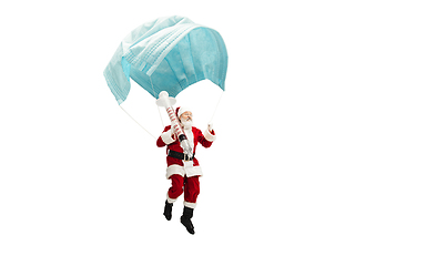 Image showing Santa Claus flying on huge face mask like on balloon isolated on white background