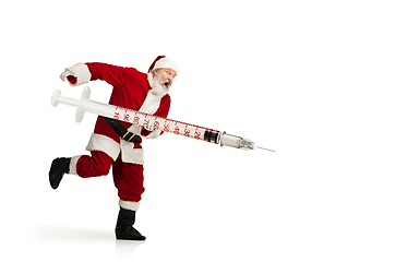 Image showing Santa Claus holding huge vaccine against COVID like Christmas gift isolated on white background