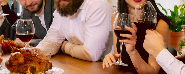 Image showing Hands of young friends, colleagues during beer drinking, having fun, laughting and celebrating together. Flyer with copyspace