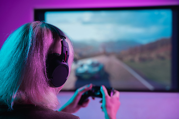 Image showing Back view shot of professional gamer playing online video game on his personal computer.