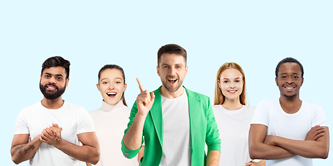 Image showing Group portrait of emotional people on blue studio background