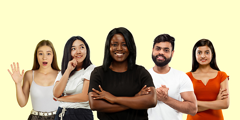 Image showing Group portrait of emotional people on yellow studio background