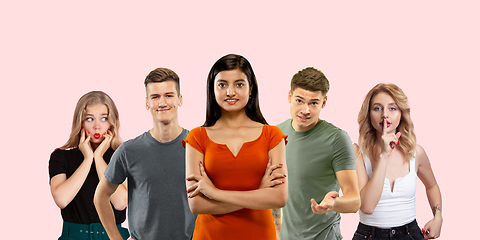 Image showing Group portrait of emotional people on coral pink studio background