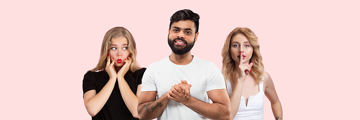 Image showing Group portrait of emotional people on coral pink studio background