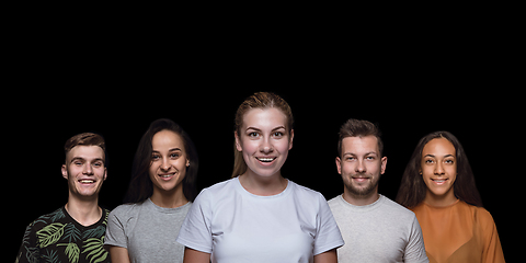 Image showing Group portrait of emotional people on black studio background