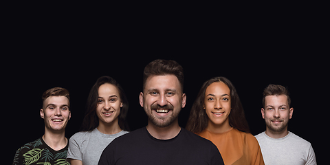 Image showing Group portrait of emotional people on black studio background