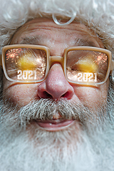 Image showing Close up Santa Claus in glasses with a reflection of 2021 Happy New Year