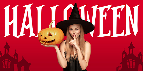 Image showing Young woman in hat as a witch on scary red background