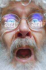 Image showing Close up Santa Claus in glasses with a reflection of 2021 Happy New Year