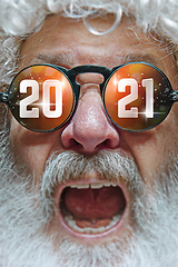 Image showing Close up Santa Claus in glasses with a reflection of 2021 Happy New Year