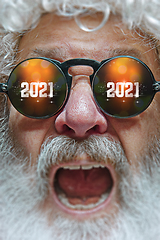 Image showing Close up Santa Claus in glasses with a reflection of 2021 Happy New Year