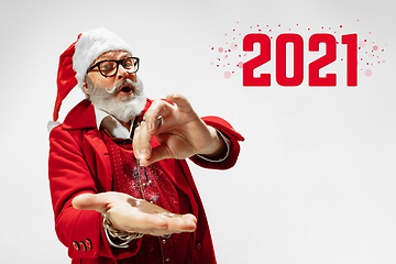 Image showing Emotional Santa Claus in eyewear greeting with New Year 2021 and Christmas. Copyspace