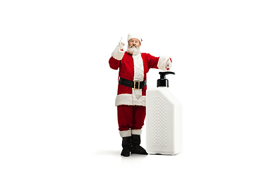 Image showing Santa Claus with the huge antiseptics against COVID like Christmas gift isolated on white background