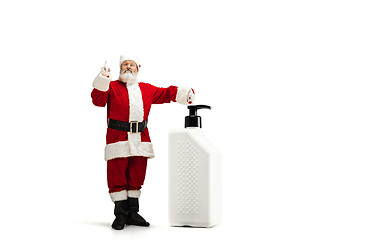 Image showing Santa Claus with the huge antiseptics against COVID like Christmas gift isolated on white background