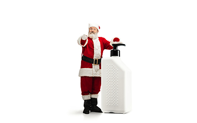 Image showing Santa Claus with the huge antiseptics against COVID like Christmas gift isolated on white background