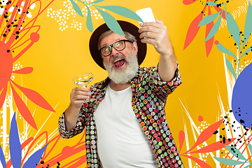 Image showing Senior hipster man using devices, gadgets. Tech and joyful elderly lifestyle concept. Bright illustrated background