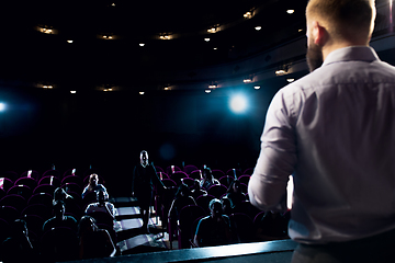 Image showing Male caucasian speaker giving presentation in hall at university or business centre workshop