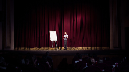 Image showing Male caucasian speaker giving presentation in hall at university or business centre workshop