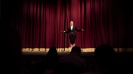 Image showing Female caucasian speaker giving presentation in hall at university or business centre workshop