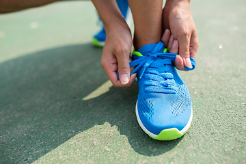 Image showing Woman trying the shoelace