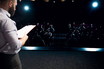 Image showing Male caucasian speaker giving presentation in hall at university or business centre workshop