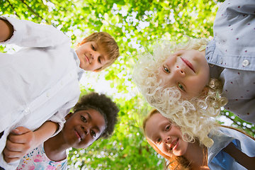 Image showing Interracial group of kids, girls and boys playing together at the park in summer day