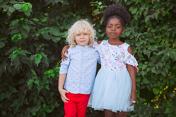 Image showing Interracial kids, friends, girl and boy playing together at the park in summer day