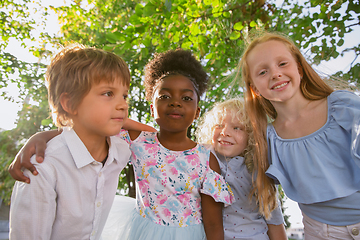 Image showing Interracial group of kids, girls and boys playing together at the park in summer day