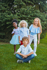 Image showing Interracial group of kids, girls and boys playing together at the park in summer day