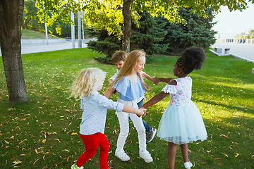 Image showing Interracial group of kids, girls and boys playing together at the park in summer day