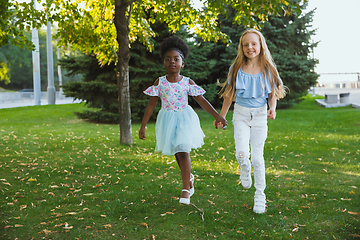 Image showing Interracial kids, friends, girls playing together at the park in summer day