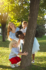 Image showing Interracial group of kids, girls and boys playing together at the park in summer day