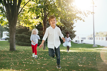 Image showing Interracial group of kids, girls and boys playing together at the park in summer day