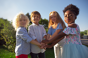 Image showing Interracial group of kids, girls and boys playing together at the park in summer day